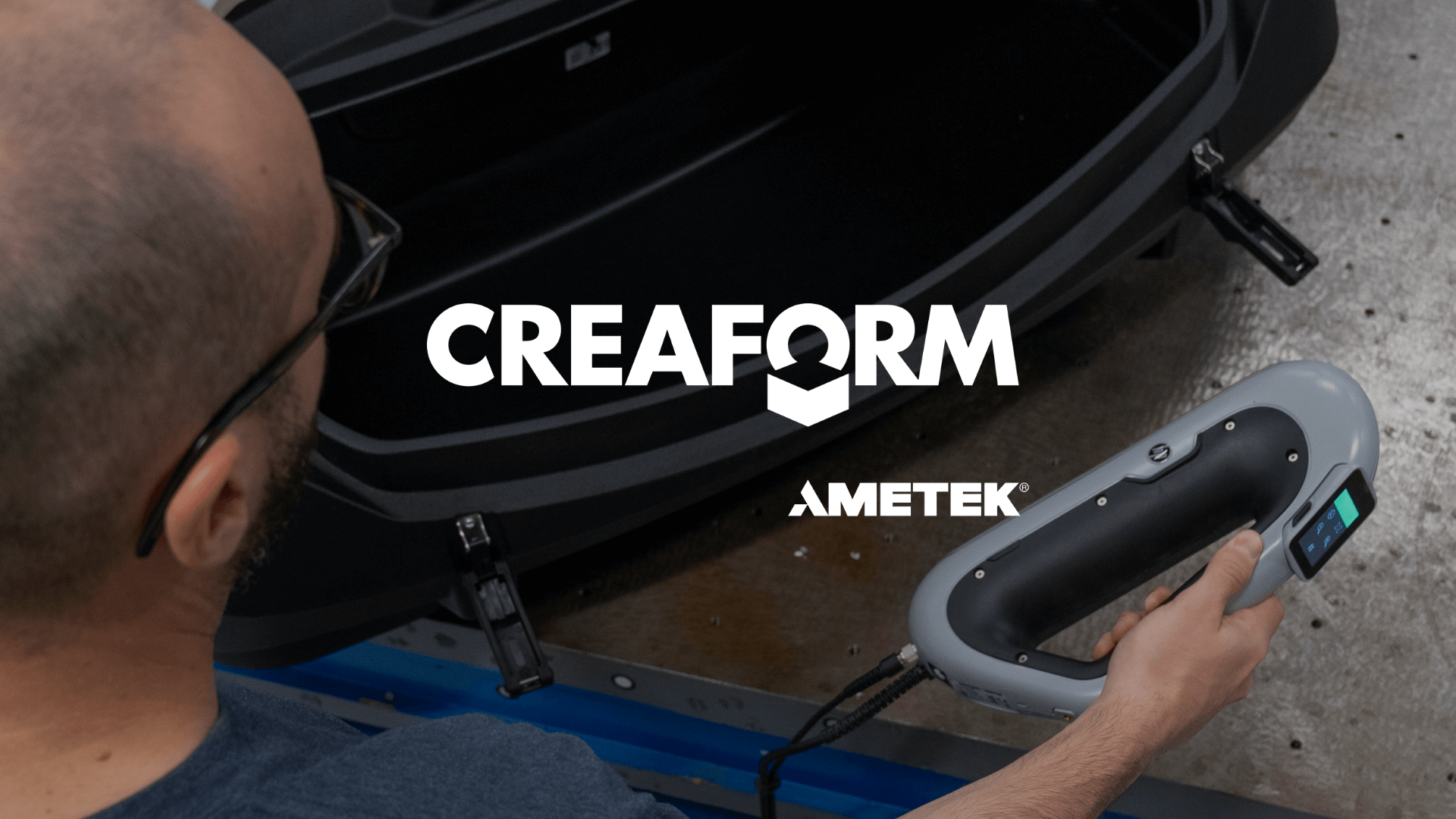 Technician using a professional 3D scanner on a black automotive part, featuring the Creaform and AMETEK logos prominently